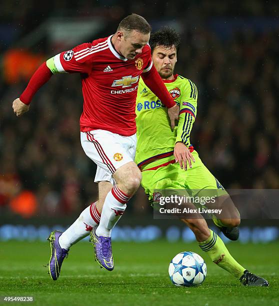 Wayne Rooney of Manchester United is tackled by Georgi Schennikov of CSKA Moscow during the UEFA Champions League Group B match between Manchester...