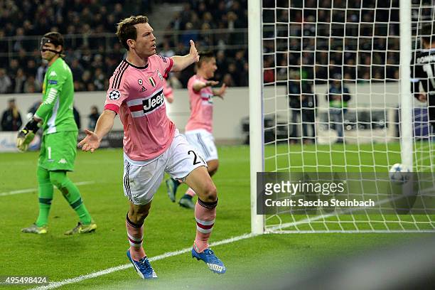 Stephan Lichtsteiner of Juventus celebrates after scoring his team's first goal during the UEFA Champions League group stage match between VfL...