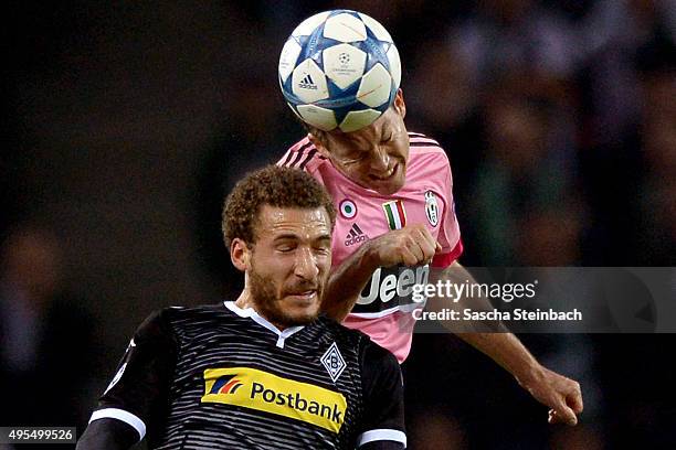 Stephan Lichtsteiner of Juventus and Fabian Johnson of Moenchengladbach battle for a header during the UEFA Champions League group stage match...