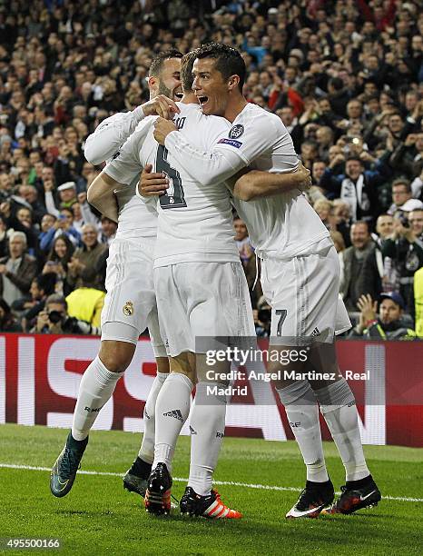 Nacho Fernandez of Real Madrid celebrates with Cristiano Ronaldo and Jese Rodriguez after scoring the opening goal during the UEFA Champions League...