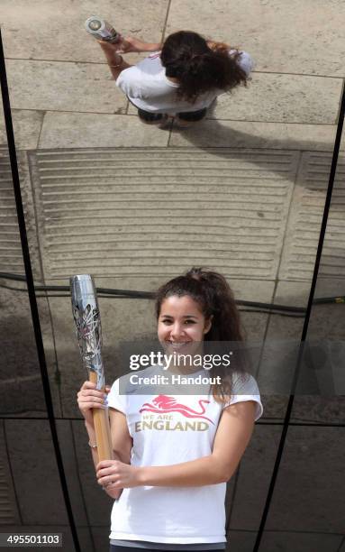 In this handout image provided by Glasgow 2014 Ltd, Team England Gymnast Jade Faulkner poses with the Queen's Baton by the planetarium as the Glasgow...