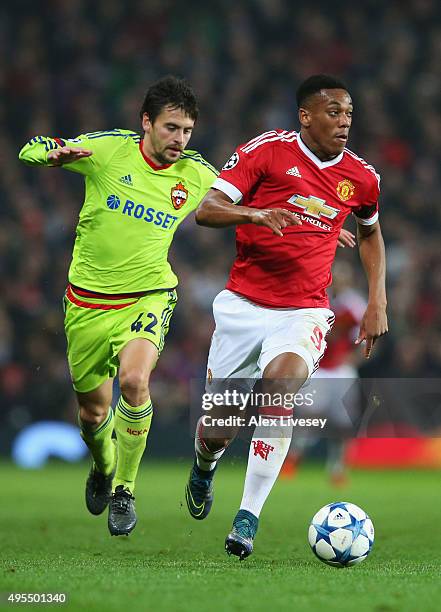 Anthony Martial of Manchester United is chased by Georgi Schennikov of CSKA Moscow during the UEFA Champions League Group B match between Manchester...