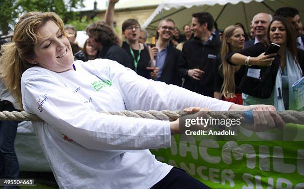 Female deputies compete during the 27th annual tug of war between House of Lords and House of Commons at Westminster College Gardens in London,...