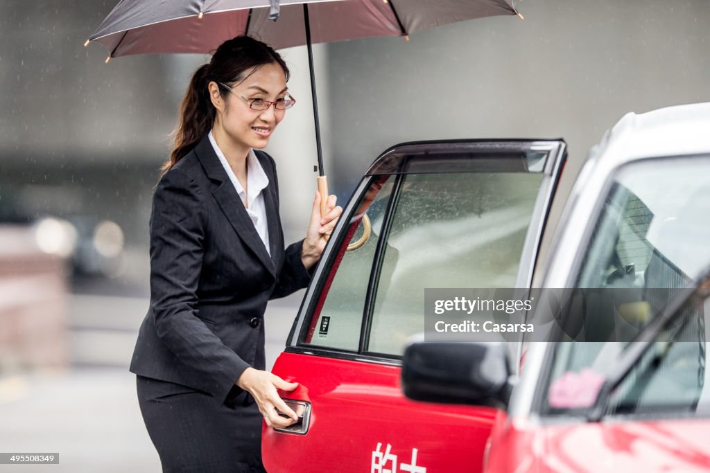 Asian Businesswoman calling a taxi
