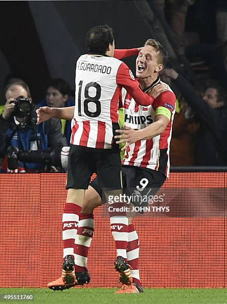 Eindhoven's Dutch forward Luuk De Jong celebrates with PSV Eindhoven's Mexican midfielder Andres Guardado after scoring during the UEFA Champions...