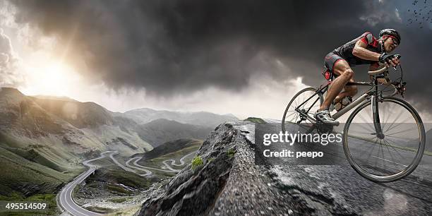 cyclist climbs to the top - racing bicycle stock pictures, royalty-free photos & images