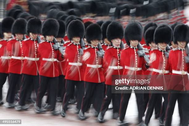 Grenadier Guards march along the Mall ahead of the Queen's procession for the annual State Opening of Parliament in London on June 4, 2014. The State...