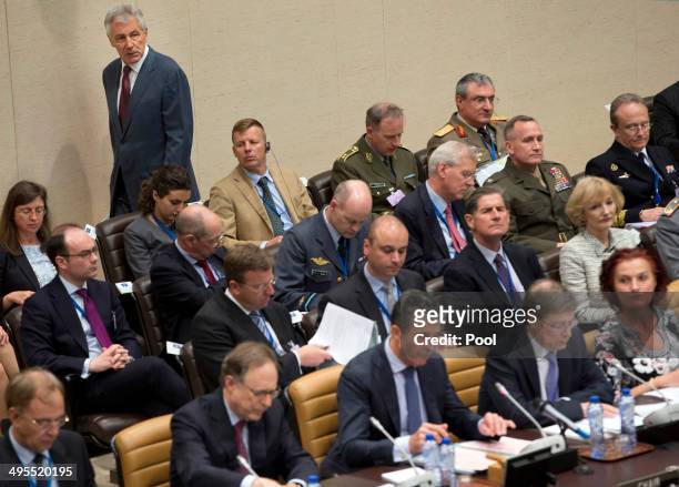 Defense Secretary Chuck Hagel, background left, arrives for a meeting of NATO defense ministers in the format of the North Atlantic Council with...