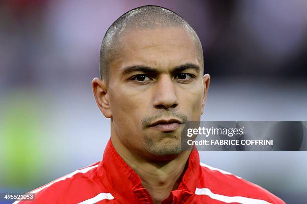 Switzerland's midfielder Goekhan Inler listens to the national anthem prior to a friendly football match between Switzerland and Peru on June 3 in...