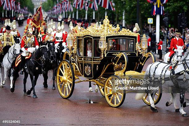 Queen Elizabeth II returns to Buckingham Palace in the new Diamond Jubilee state coach following the State Opening of Parliament on June 4, 2014 in...