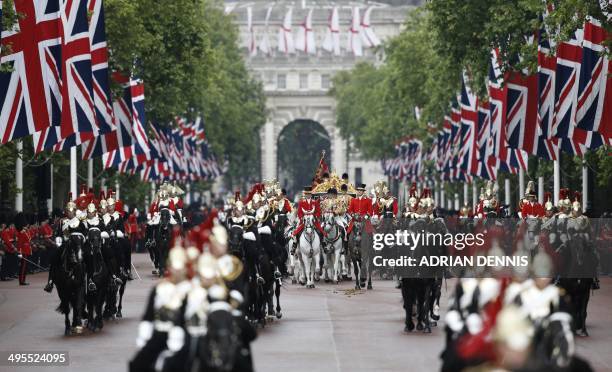 Britain's Queen Elizabeth II and Prince Philip, Duke of Edinburgh ride in the Diamond Jubilee state carriage escorted by members of the Household...