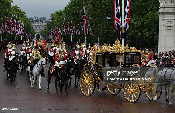 Britain's Queen Elizabeth II and Prince Philip, Duke of Edinburgh ride in the Diamond Jubilee state carriage escorted by members of the Household...