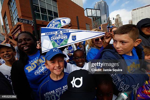 Fans hold pennants during a parade and celebration in honor of the Kansas City Royals' World Series win on November 3, 2015 in Kansas City, Missouri.