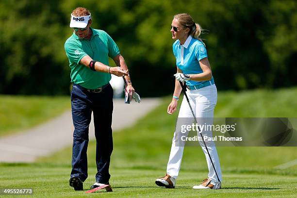 Miguel Angel Jimenez of Spain gestures as he speaks with his wife Susanne Jimenez during the Lyoness Open preview day at the Diamond Country Club on...