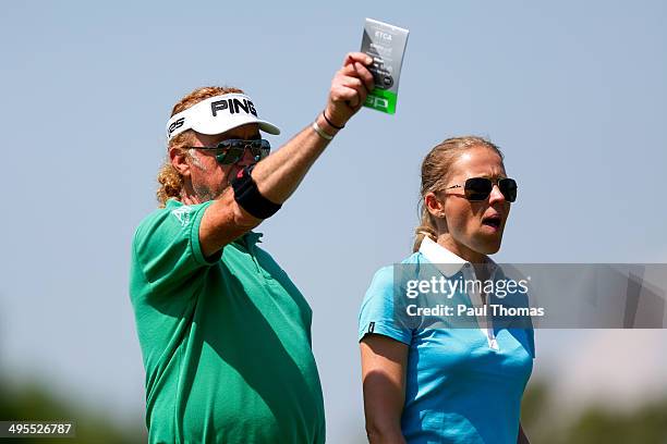 Miguel Angel Jimenez of Spain gestures as he speaks with his wife Susanne Jimenez during the Lyoness Open preview day at the Diamond Country Club on...