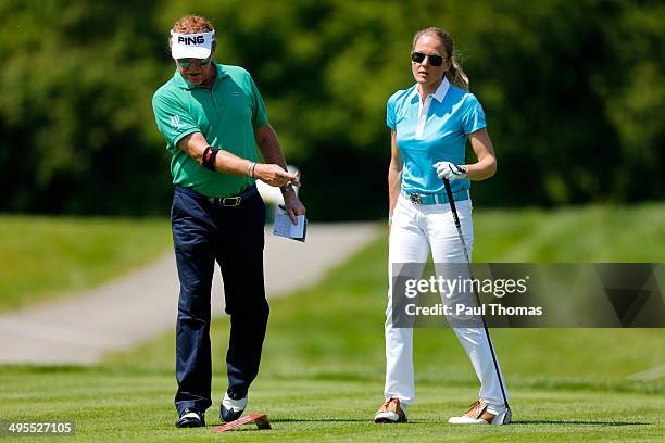 Miguel Angel Jimenez of Spain gestures as he speaks with his wife Susanne Jimenez during the Lyoness Open preview day at the Diamond Country Club on...