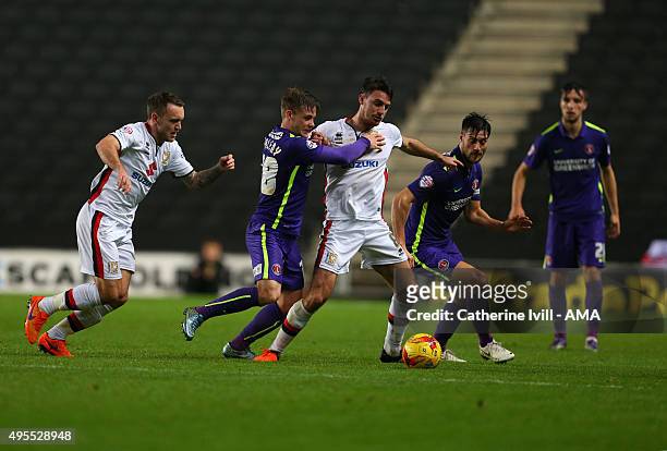 Lee Hodson and Darren Potter of MK Dons battle it out with Conor McAleny and Johnnie Jackson of Charlton Athletic during the Sky Bet Championship...
