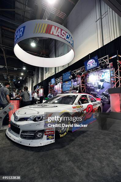 Scarlet Racing Booth Attendees gather at the NASCAR booth during the Specialty Equipment ...