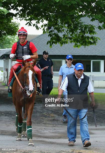 Kentucky Derby and Preakness winner California Chrome, with exercise rider Willie Delgado up and lead by assistant trainer Alan Sherman heads to his...