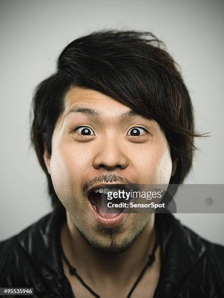 portrait of a young happy japanese man looking at camera - hyper japan stock pictures, royalty-free photos & images