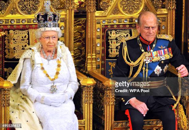 Queen Elizabeth II sits with Prince Philip, Duke of Edinburgh as she delivers her speech during the State Opening of Parliament in the House of Lords...