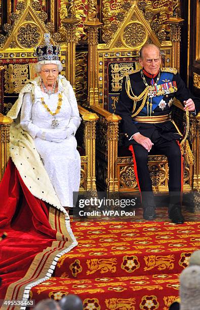 Queen Elizabeth II sits with Prince Philip, Duke of Edinburgh as she delivers her speech during the State Opening of Parliament in the House of Lords...