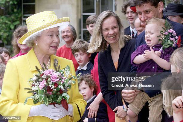 Two year old Frederik Azzopardi cries as he refuses to give Queen Elizabeth ll a posy of flowers during The Queen's and visit to University Collage...
