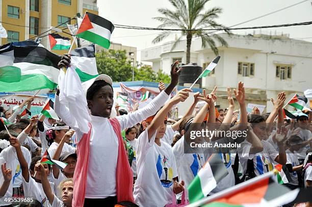 Palestinian children take part in a demonstration outside the International Committee of the Red Cross headquarters in solidarity with the...