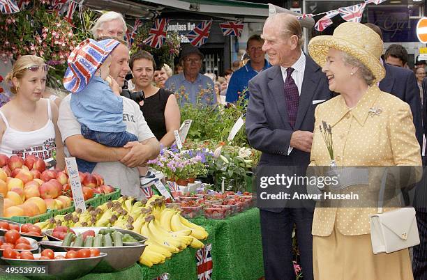 Queen Elizabeth II and Prince Philip, Duke of Edinburgh visit market stalls in Kingston town centre during the Queen's Golden Jubilee visit to West...