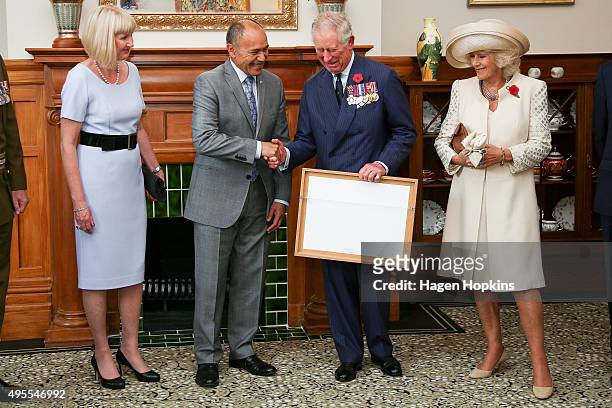 Governor-General Sir Jerry Mateparae presents Prince Charles, Prince of Wales with his new Military Warrants while Lady Janine Mateparae and Camilla,...