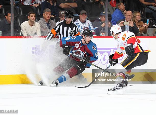 Ben Street of the Colorado Avalanche skates against Michael Frolik of the Calgary Flames during the third period at the Pepsi Center on November 3,...