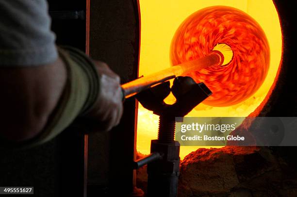 Ken Ostrow, of Newton, blows glass at APG studio in Cambridge, Mass. On March 11, 2014.