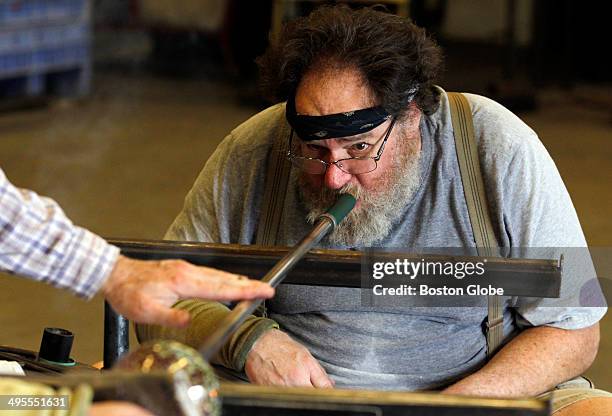 Ken Ostrow, of Newton, blows glass at APG studio in Cambridge, MA March 11, 2014.