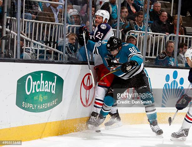 Matt Tennyson of the San Jose Sharks connects on a check against David Clarkson of the Columbus Blue Jackets during a NHL game at the SAP Center at...