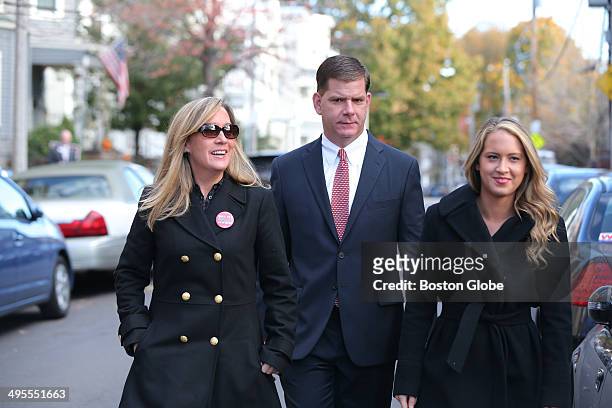 Walking up to vote. Rep. Marty Walsh voted with his partner Lorrie Higgins, left, and her daughter Lauren Campbell at the Cristo Rey School, 100...
