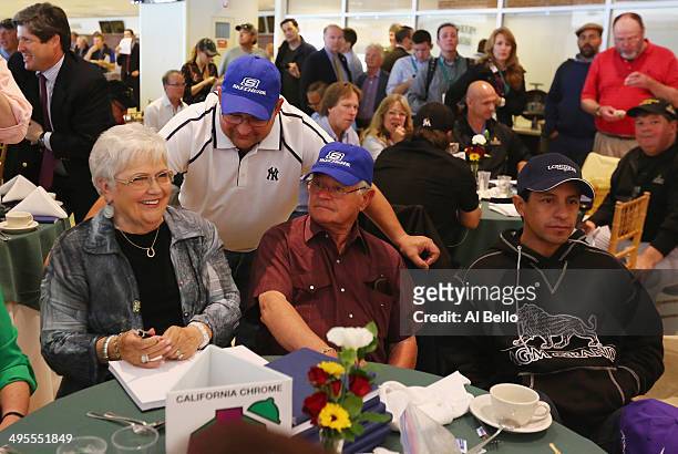 Assistant Trainer of California Chrome Alan Sherman speaks to his Mother Faye and Father Art who is the head trainer as Jockey Victor Espinoza looks...