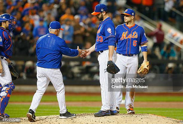 Matt Harvey of the New York Mets hands the ball to manager Terry Collins as he leaves in the ninth inning against the Kansas City Royals during game...