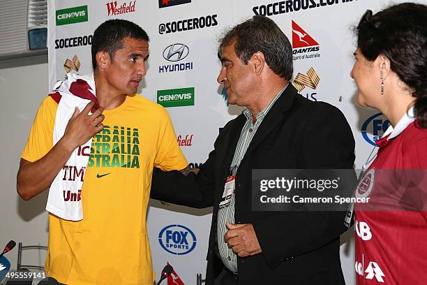 Tim Cahill of the Socceroos is presented with a personalised top from Desportiva Ferroviaria during an Australian Socceroos press conference at Arena...