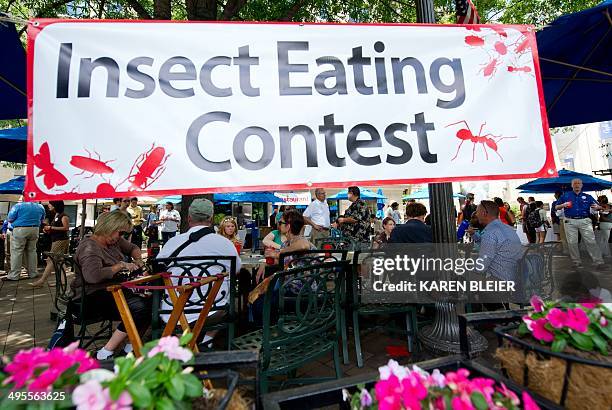 Patrons sit and eat various edible insects June 4, 2014 during a global Pestaurant event sponsored by Ehrlich Pest Control, held at the Occidental...