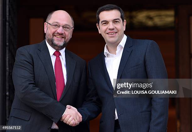 Greek prime minister Alexis Tsipras shakes hands with European Parliament President Martin Schulz prior to their talks in Athens on November 4, 2015....