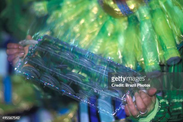 Drummer playing chocalho, a generic name for shaker in Portuguese. Samba schools parade - Rio de Janeiro carnival, Brazil. There are various types of...