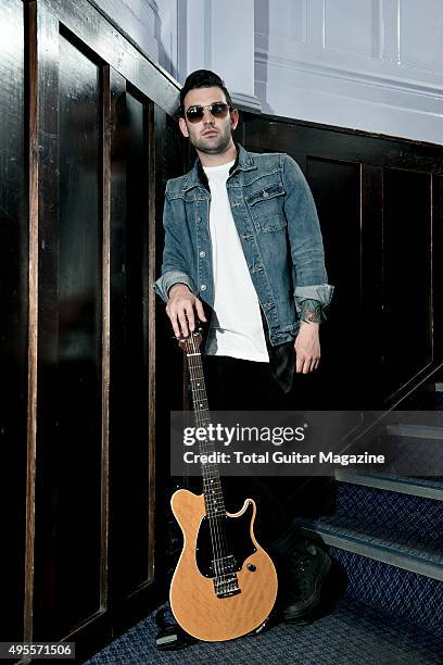 Portrait of musician Jack Fowler, guitarist with American post-hardcore group Sleeping With Sirens, photographed backstage before a live performance...