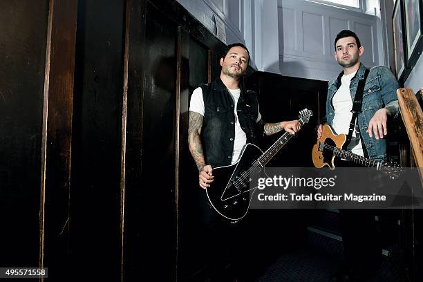 Portrait of musicians Jack Fowler and Nick Martin, guitarists with American post-hardcore group Sleeping With Sirens, photographed backstage before a...