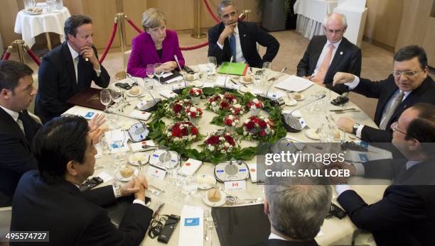 President Barack Obama sits alongside German Chancellor Angela Merkel, British Prime Minister David Cameron, Italian President Matteo Renzi, Japanese...