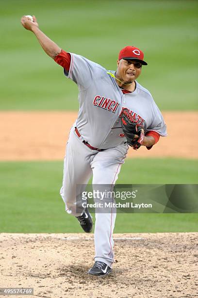 Alfredo Simon of the Cincinnati Reds takes a swing during a baseball game against the Washington Nationals on May 21, 2014 at Nationals Park in...