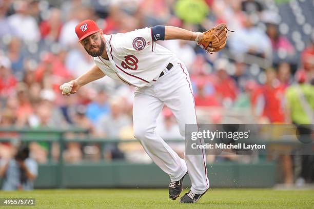 Kevin Frandsen of the Washington Nationals fields a ground ball during a baseball game against the Cincinnati Reds on May 21, 2014 at Nationals Park...