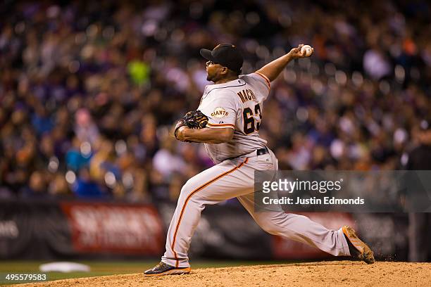 Jean Machi of the San Francisco Giants pitches against the Colorado Rockies at Coors Field on May 20, 2014 in Denver, Colorado. The Rockies defeated...