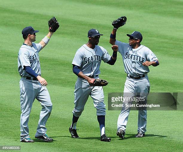 Cole Gillespie, James Jones, and Endy Chavez of the Seattle Mariners celebrate after the game against the Atlanta Braves at Turner Field on June 4,...
