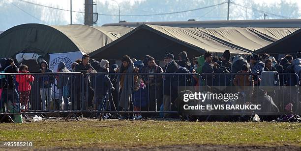 Migrants and refugees queue to enter a transit camp in Slavonski Brod on November 4, 2015. Thousands of newly arrived migrants and asylum seekers are...