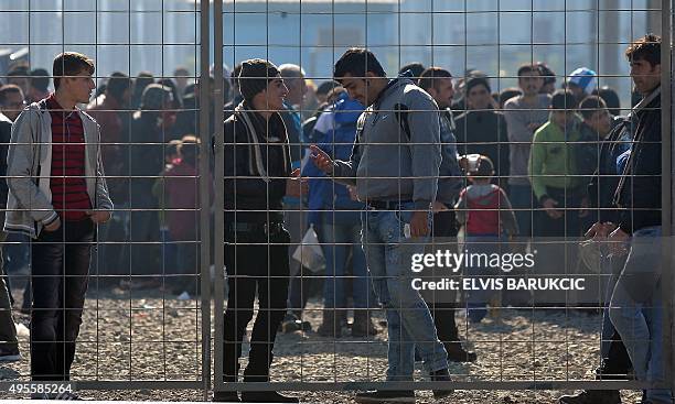 Migrants and refugees queue to enter a transit camp in Slavonski Brod on November 4, 2015. Thousands of newly arrived migrants and asylum seekers are...